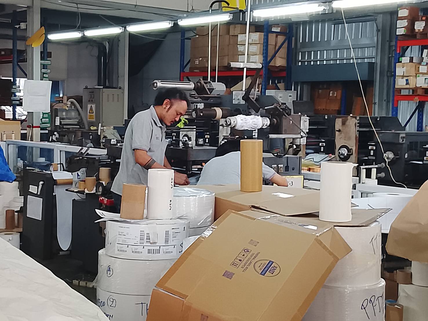 Worker operating letterpress machine at MDCC factory